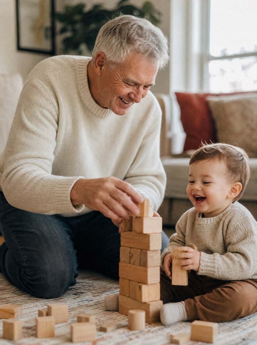 A grandfather on the living-room floor building blocks with his grandchild