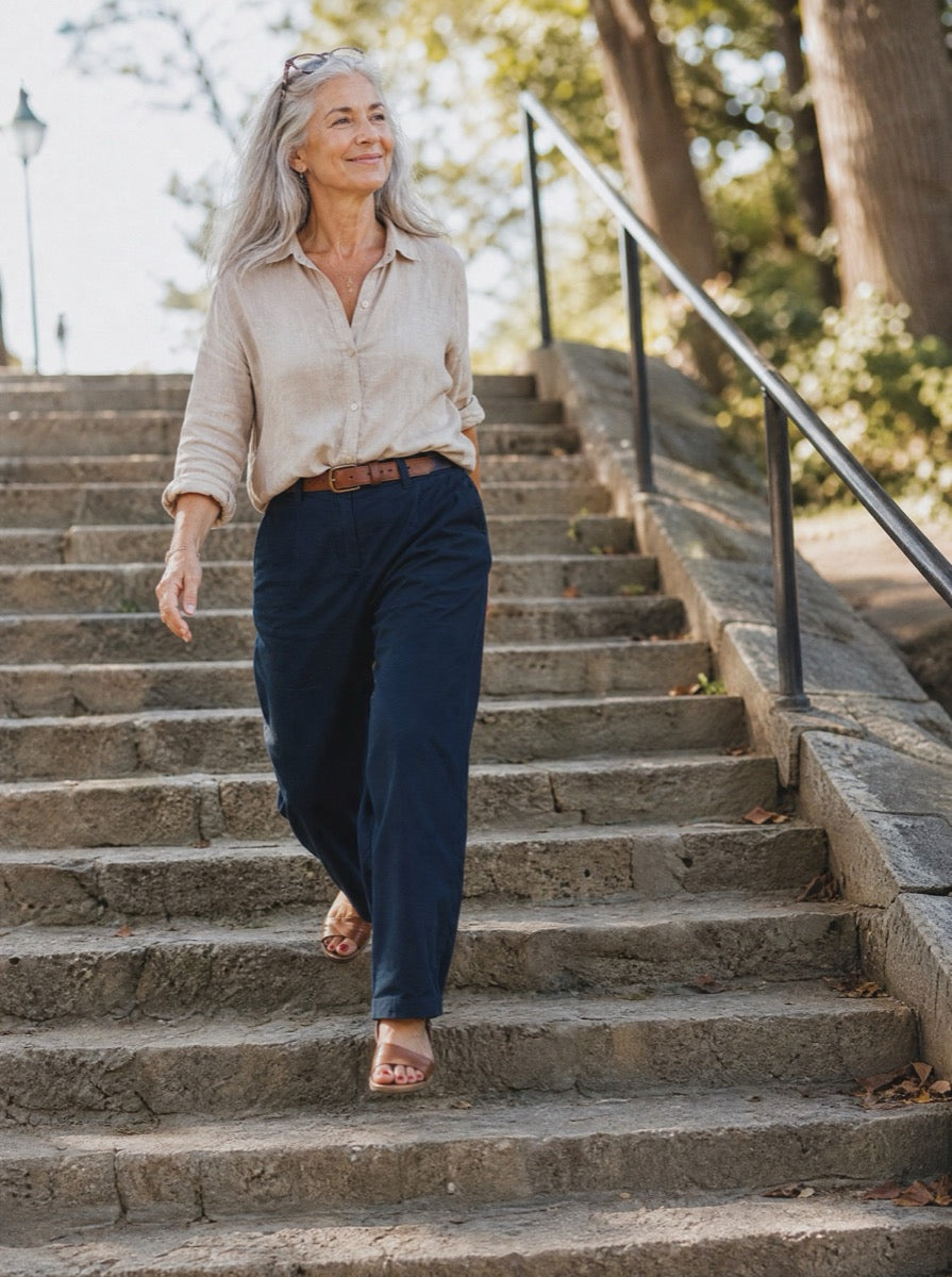 A woman in her sixties taking park steps two at a time without the handrail